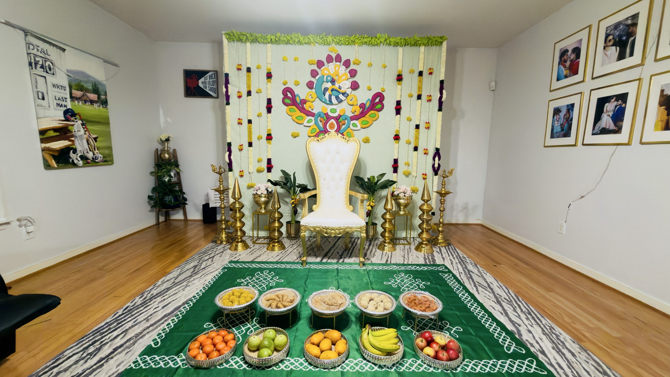Peacock-themed traditional celebration backdrop with a white and gold throne chair