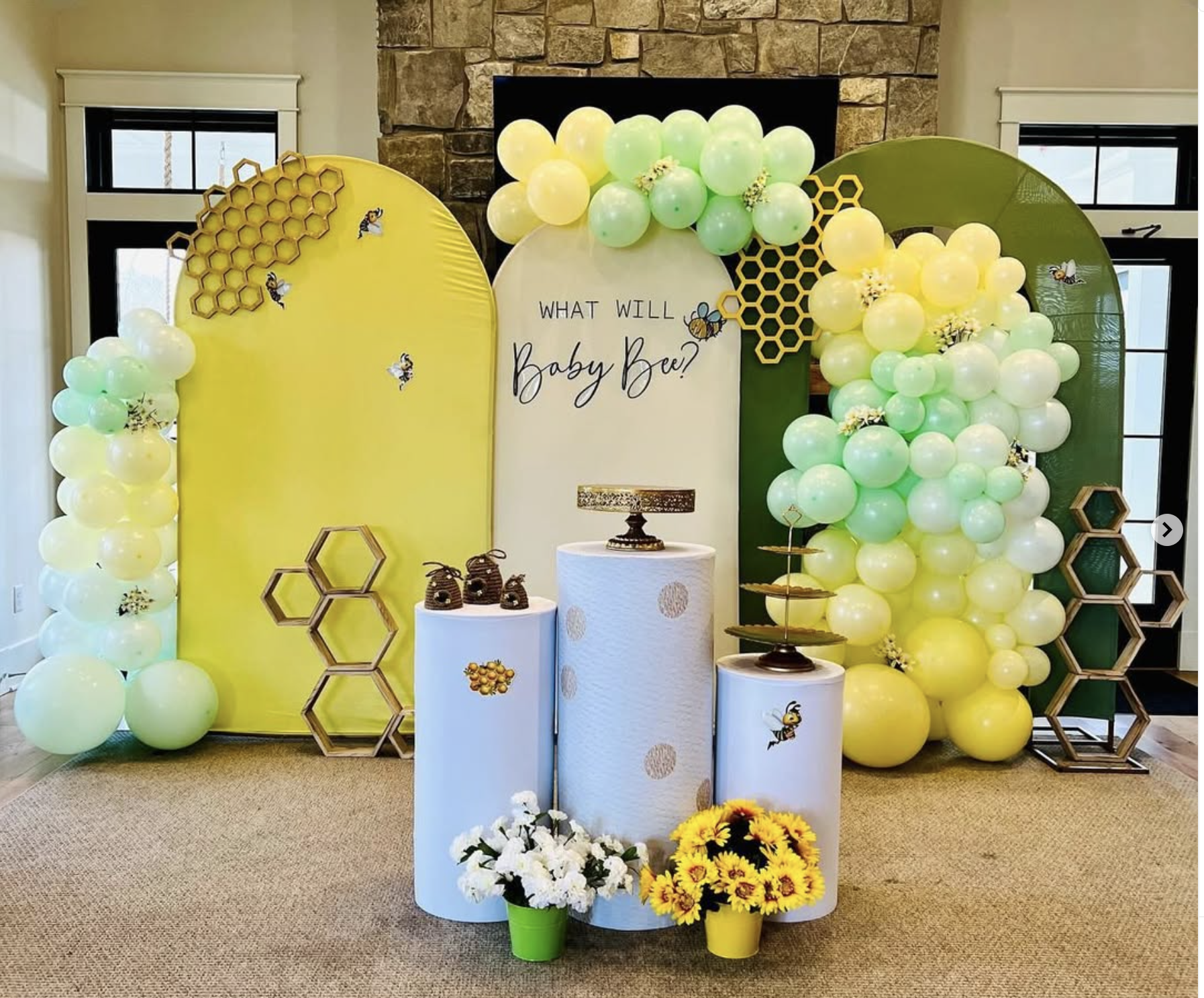 Yellow and green baby bee celebration with balloons and pedestal stands